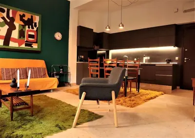 a living room with a kitchen and a dining room at Central studio in Monastiraki B in Athens