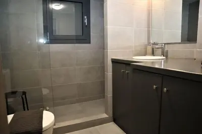 a bathroom with a toilet and a sink and a mirror at Central studio in Monastiraki B in Athens