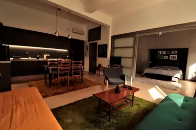 a living room with a bed and a dining room at Central studio in Monastiraki B in Athens