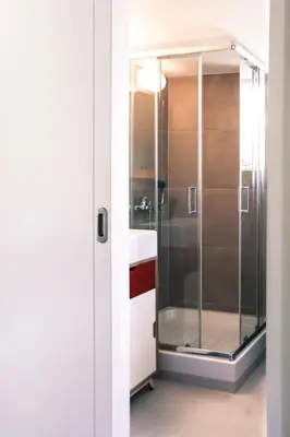 a bathroom with a shower with a glass door at ViLLaRa: Style, Hospitality & Design (City Center) in Athens