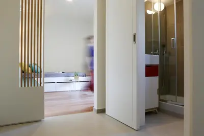 a hallway with a door leading to a living room at ViLLaRa: Style, Hospitality & Design (City Center) in Athens