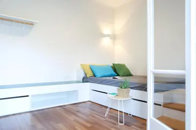 a small room with a bed and a table at ViLLaRa: Style, Hospitality & Design (City Center) in Athens