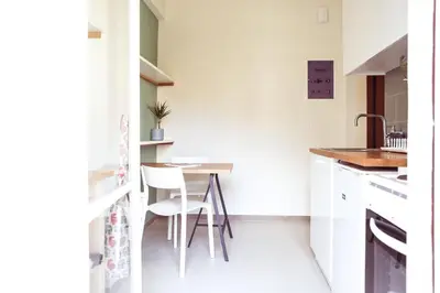a small kitchen with a table and chairs in it at ViLLaRa: Style, Hospitality & Design (City Center) in Athens