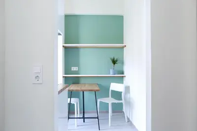 a room with a table and two chairs and a shelf at ViLLaRa: Style, Hospitality & Design (City Center) in Athens
