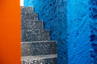 a set of stairs next to a blue wall at Architect designed studio with green rooftop! EP7R in Athens