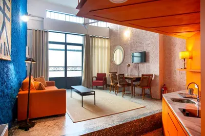 a living room with a couch and a table at Architect designed studio with green rooftop! EP7R in Athens
