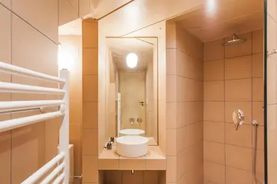 a bathroom with a sink and a shower at Architect designed studio with green rooftop! EP7L in Athens