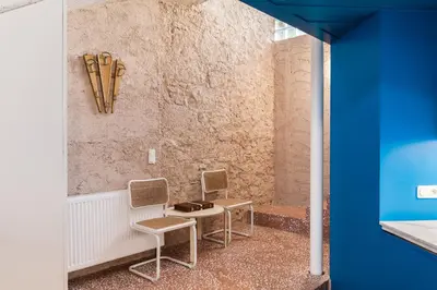 a room with two chairs and skis on the wall at Architect designed studio with green rooftop! EP7L in Athens
