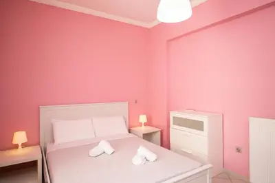 a small bedroom with a white bed with two towels at Spacious1 Bedroom Flat In The Heart Of Athens in Athens