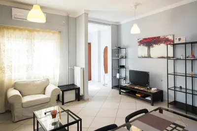 a living room with a couch and a tv at Spacious1 Bedroom Flat In The Heart Of Athens in Athens