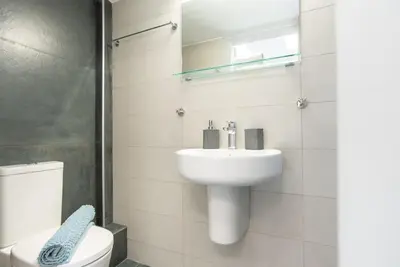 a white bathroom with a sink and a toilet at Athens Syntagma Studio in Athens