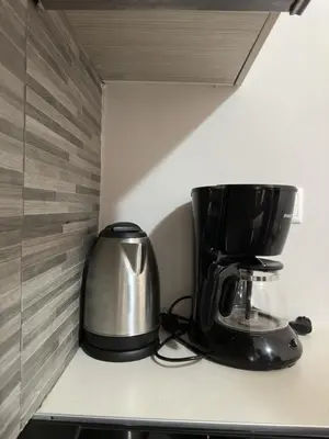 a coffee maker and a toaster on a kitchen counter at Όμορφο διαμέρισμα (Αργυρούπολη) in Athens
