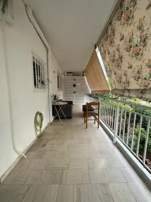 a room with a balcony with a wall with a flower mural at Όμορφο διαμέρισμα (Αργυρούπολη) in Athens