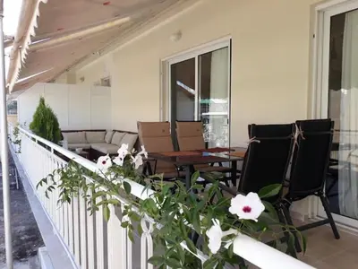 a balcony with chairs and a table and a couch at AthenSunapartment top floor 5min metro in Athens