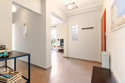 a room with a hallway with a table and a door at AthenSunapartment top floor 5min metro in Athens