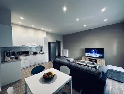 a living room with a couch and a table at Hodos Luxury APT near ATH-Airport in Markopoulo