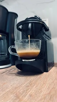a cup of coffee is being poured into a toaster at Hodos Luxury APT near ATH-Airport in Markopoulo
