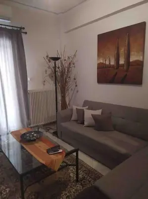 a living room with a couch and a coffee table at Stella’s cottage in Athens