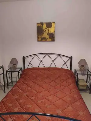 a bedroom with a large bed with two night stands at Stella’s cottage in Athens