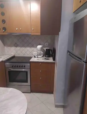 a kitchen with a stove and a refrigerator at Stella’s cottage in Athens