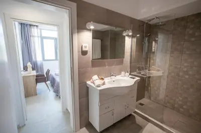 a bathroom with a sink and a shower at Attalos luxury flat Psyrri square in Athens