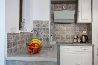 a bowl of fruit sitting on a kitchen counter at Attalos luxury flat Psyrri square in Athens