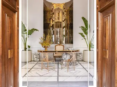 a dining room with a table and chairs and plants at The Dolli at Acropolis, A Hotel to Live in Athens