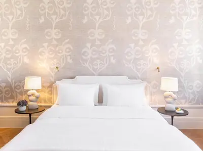 a bedroom with a white bed with white pillows at The Dolli at Acropolis, A Hotel to Live in Athens