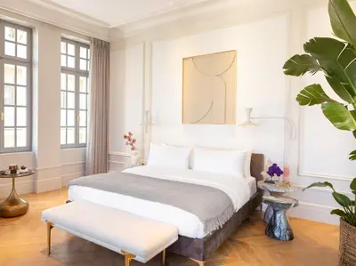 a bedroom with a king sized bed and a bench at The Dolli at Acropolis, A Hotel to Live in Athens