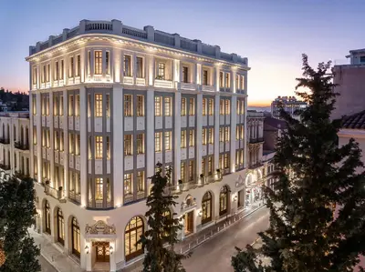 a large white building with its lights on at The Dolli at Acropolis, A Hotel to Live in Athens