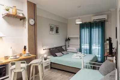 a small bedroom with a bed and a desk at Casa Tiffany Acropolis Athens by 3Cs in Athens