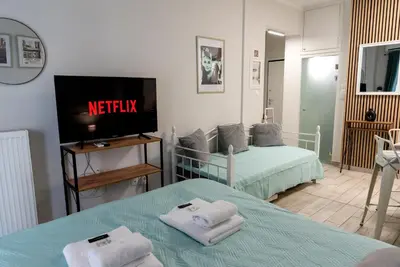 a room with two beds and a tv in it at Casa Tiffany Acropolis Athens by 3Cs in Athens