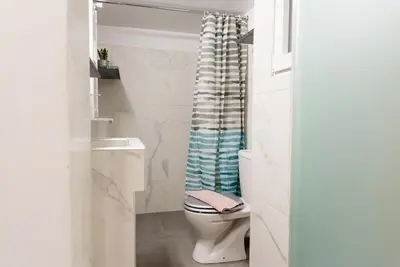 a bathroom with a toilet and a shower curtain at Casa Tiffany Acropolis Athens by 3Cs in Athens