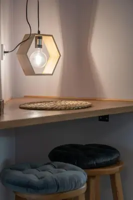 a table with a light and two stools under it at Duplex Acropolis View 2 Balconies in Athens