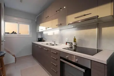 a kitchen with a sink and a counter top at Duplex Acropolis View 2 Balconies in Athens