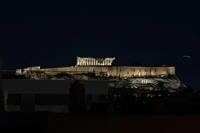 a night view of a building in the background at Duplex Acropolis View 2 Balconies in Athens