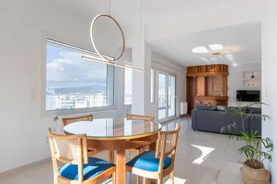 a dining room with a glass table and chairs at Delightful Penthouse in Athens