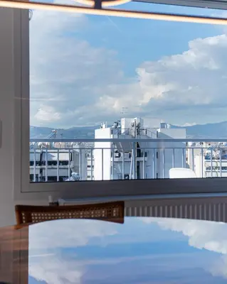 a large window with a view of a building at Delightful Penthouse in Athens