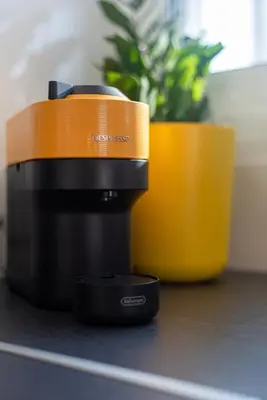 a coffee maker on a counter next to a plant at Delightful Penthouse in Athens
