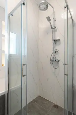 a shower with a glass door in a bathroom at Delightful Penthouse in Athens