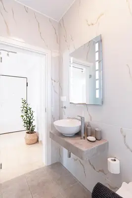 a bathroom with a sink and a mirror at Delightful Penthouse in Athens