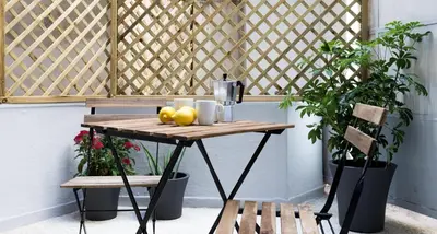 a wooden table with fruit on it next to two benches at Center of Athens: Iris cozy apartment in Athens