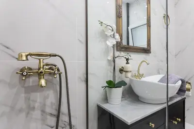 a bathroom with a sink and a mirror at Center of Athens: Iris cozy apartment in Athens