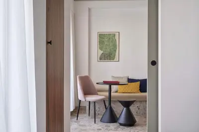 a room with a table and a chair and a table at The Social Athens Hotel, a member of Radisson Individuals in Athens