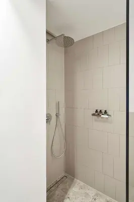 a bathroom with a shower with a shower head at The Social Athens Hotel, a member of Radisson Individuals in Athens