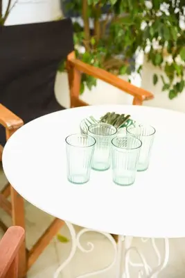 a white table with four empty glasses on it at Neoclassical Athens Residence in Athens