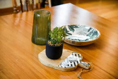 a wooden table with a potted plant and a plate at Neoclassical Athens Residence in Athens