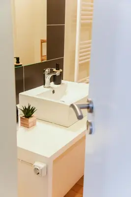 a bathroom with a white sink and a mirror at Neoclassical Athens Residence in Athens