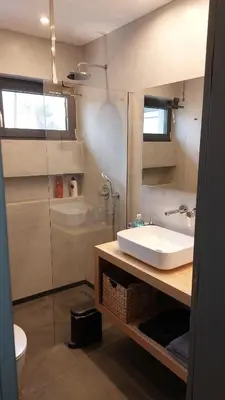 a bathroom with a sink and a shower at Charming Apartment in Chalandri in Athens