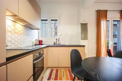a kitchen with a table and a dining room at Stylish Apartment in Thissio l Dedicated Workspace in Athens